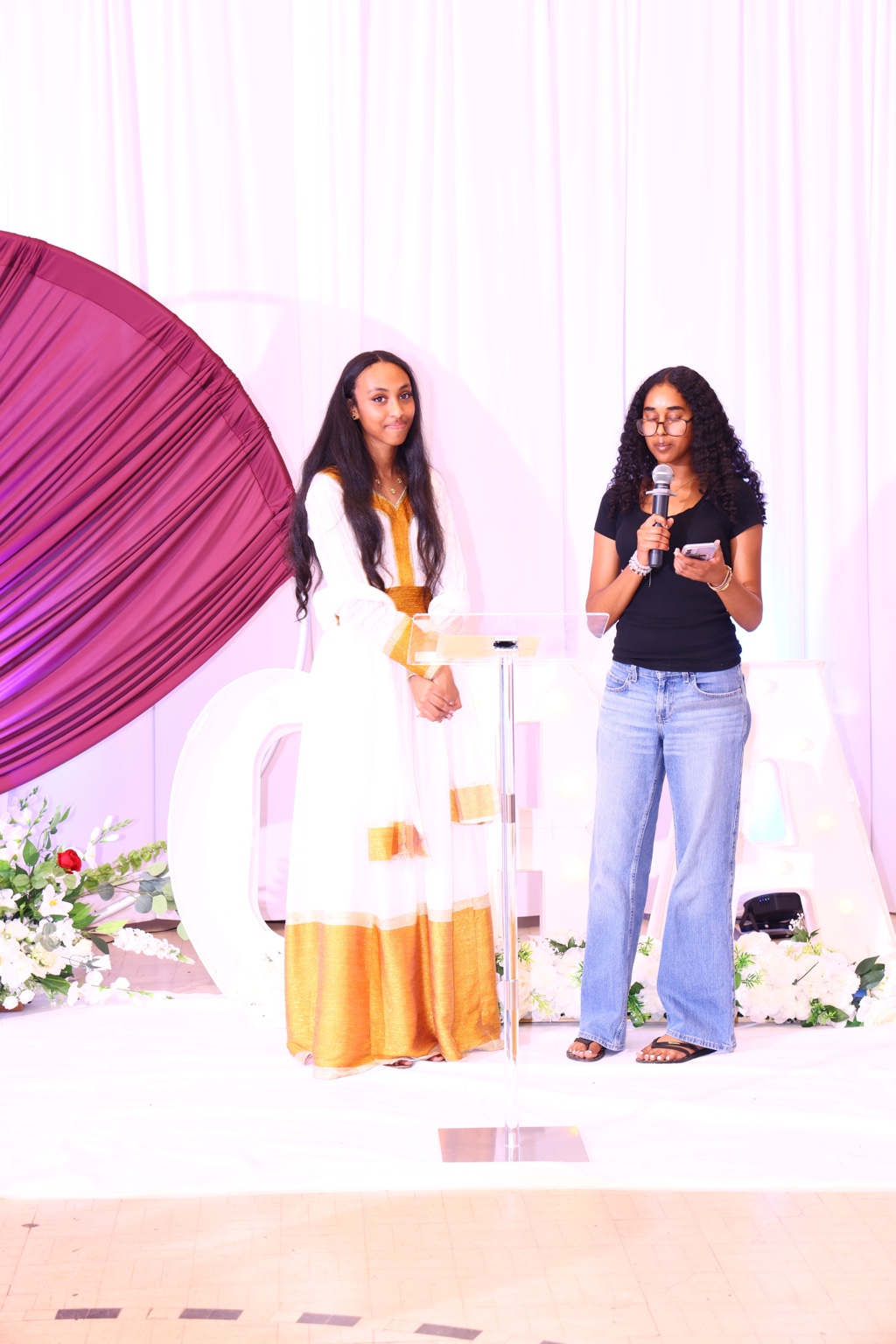 Two women on stage during a community program