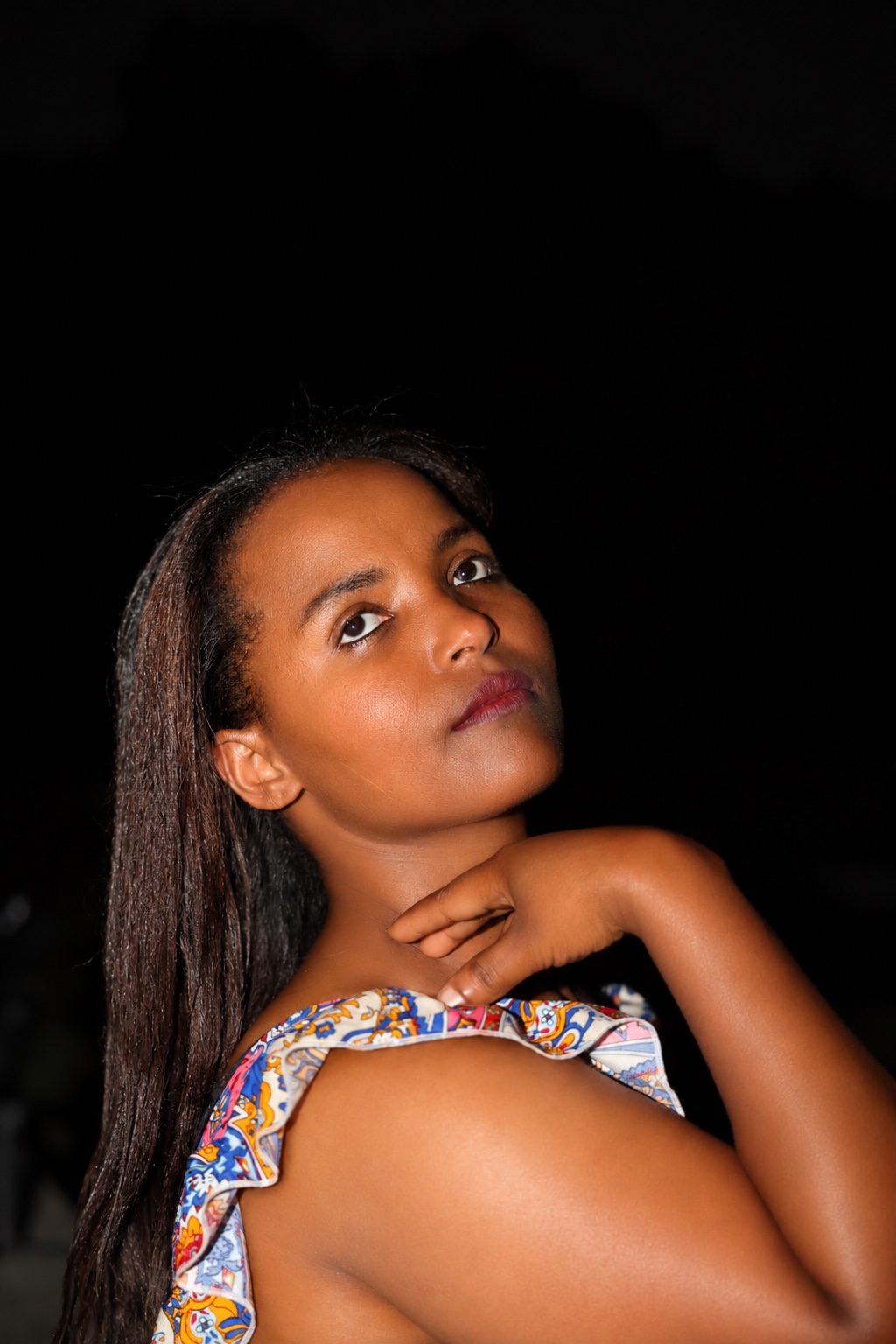 Evening portrait with a hand at the neckline