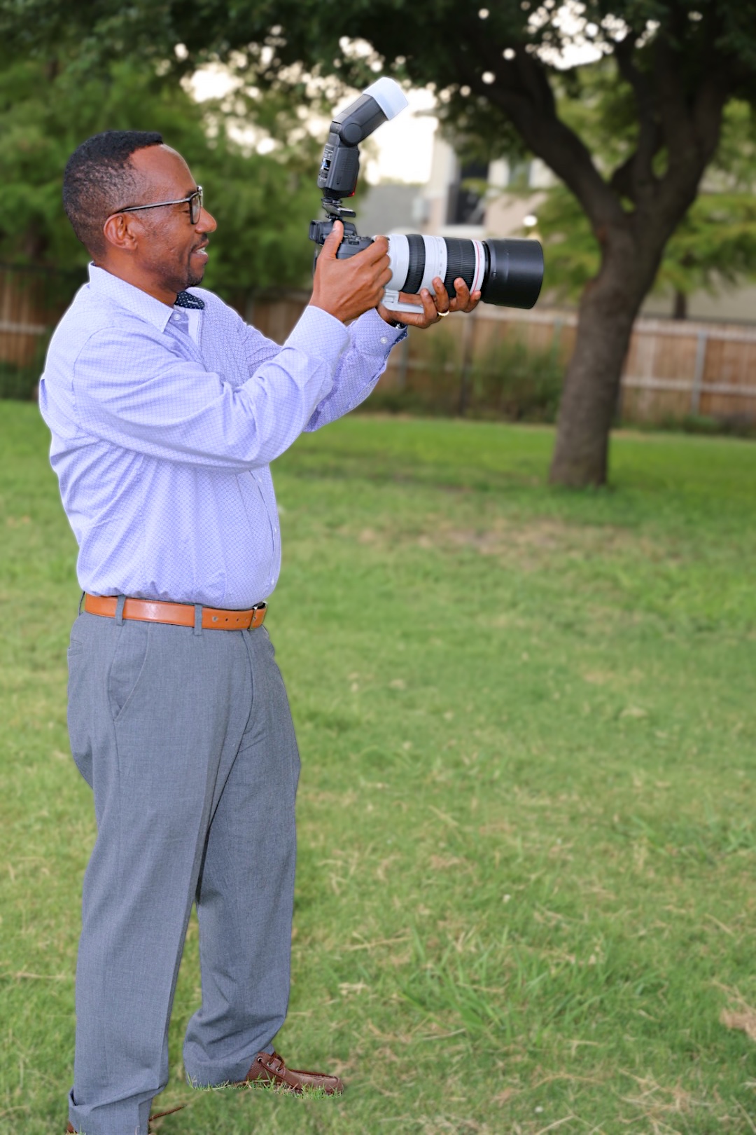 Photographer shooting outdoors with a long camera lens